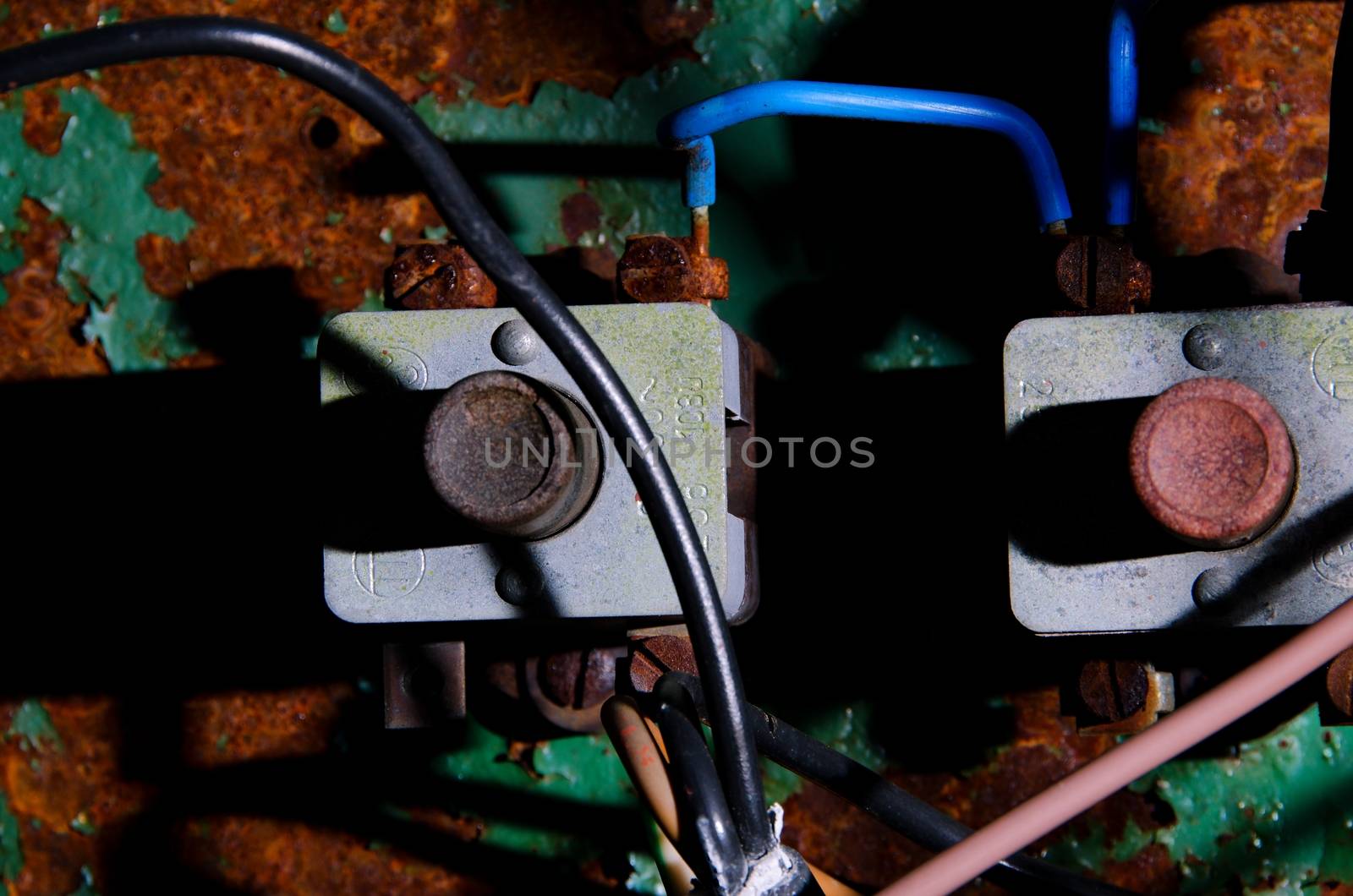 Old rusty switchboard with some colorful wires
