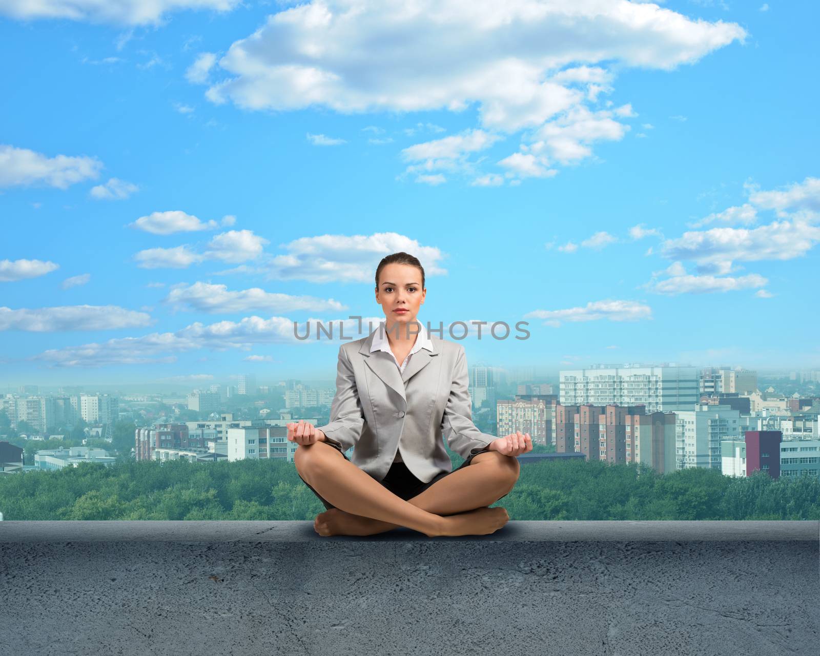 image of a businesswoman meditating on a concrete parapet