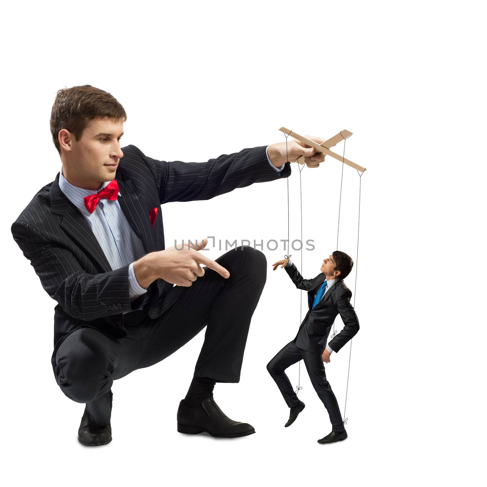 puppeteer holds the puppet business man on the ropes