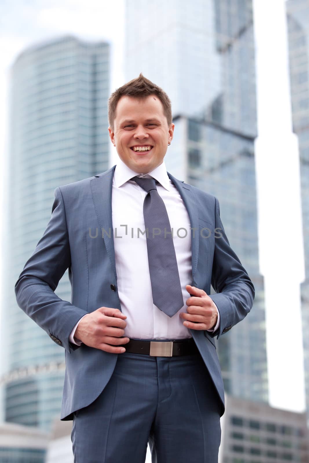 Successful businessman smiling on the background of office center