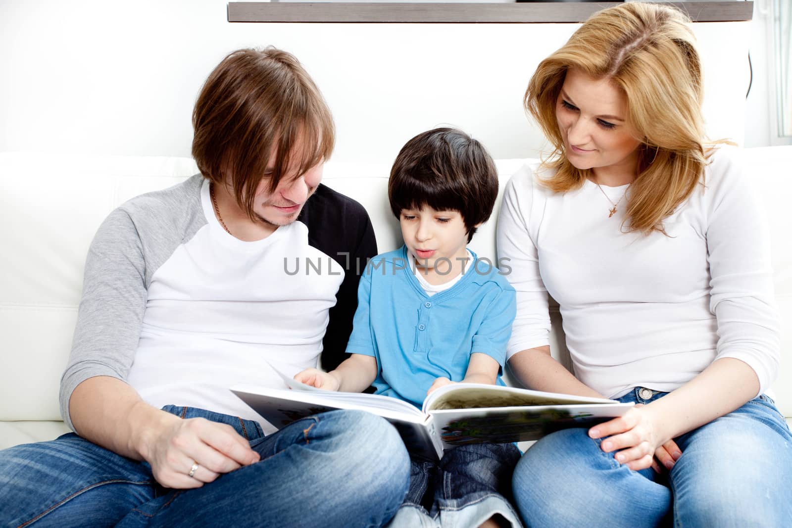 Portrait of friendly family reading book by Astroid