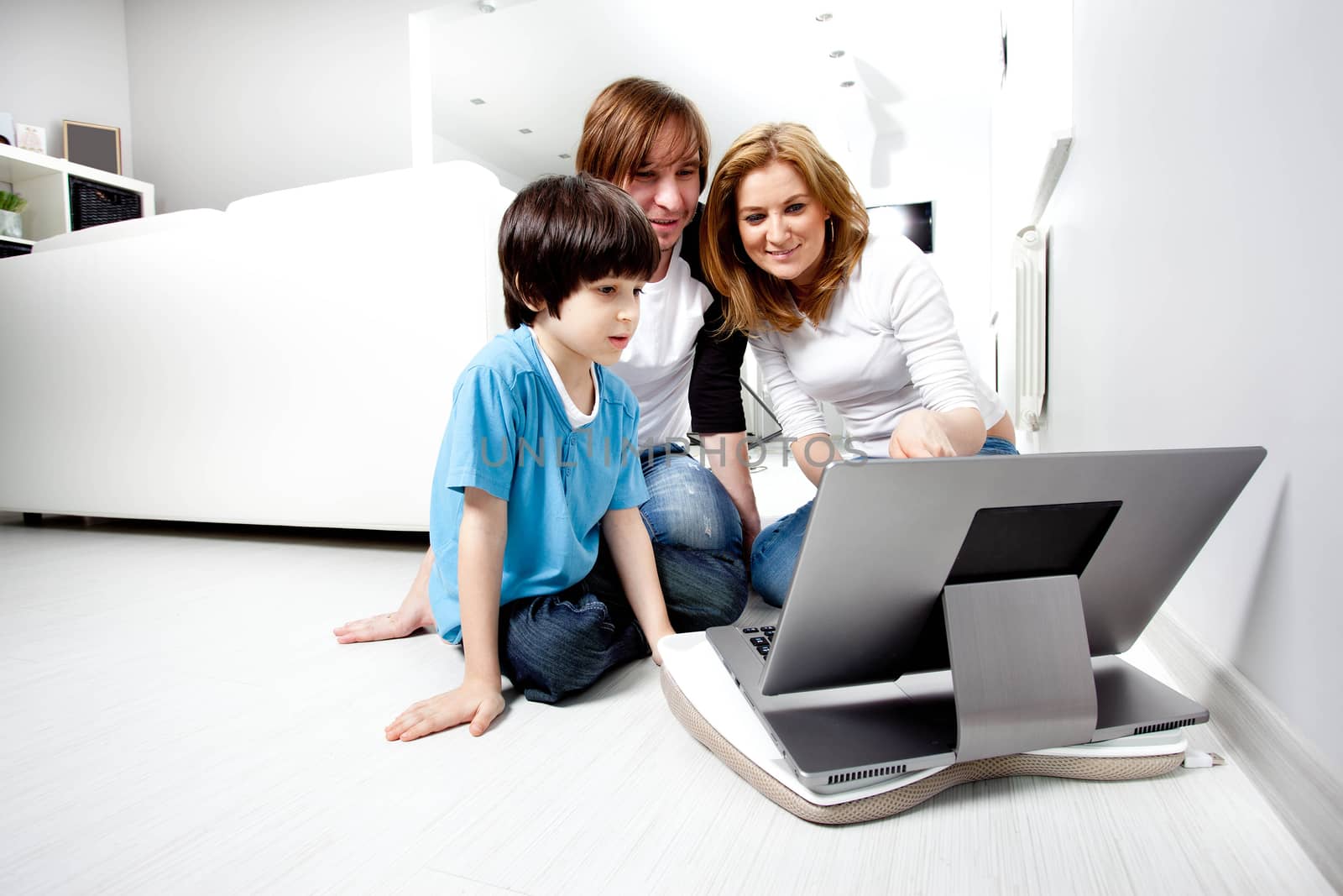 Young parents with child near laptop computer