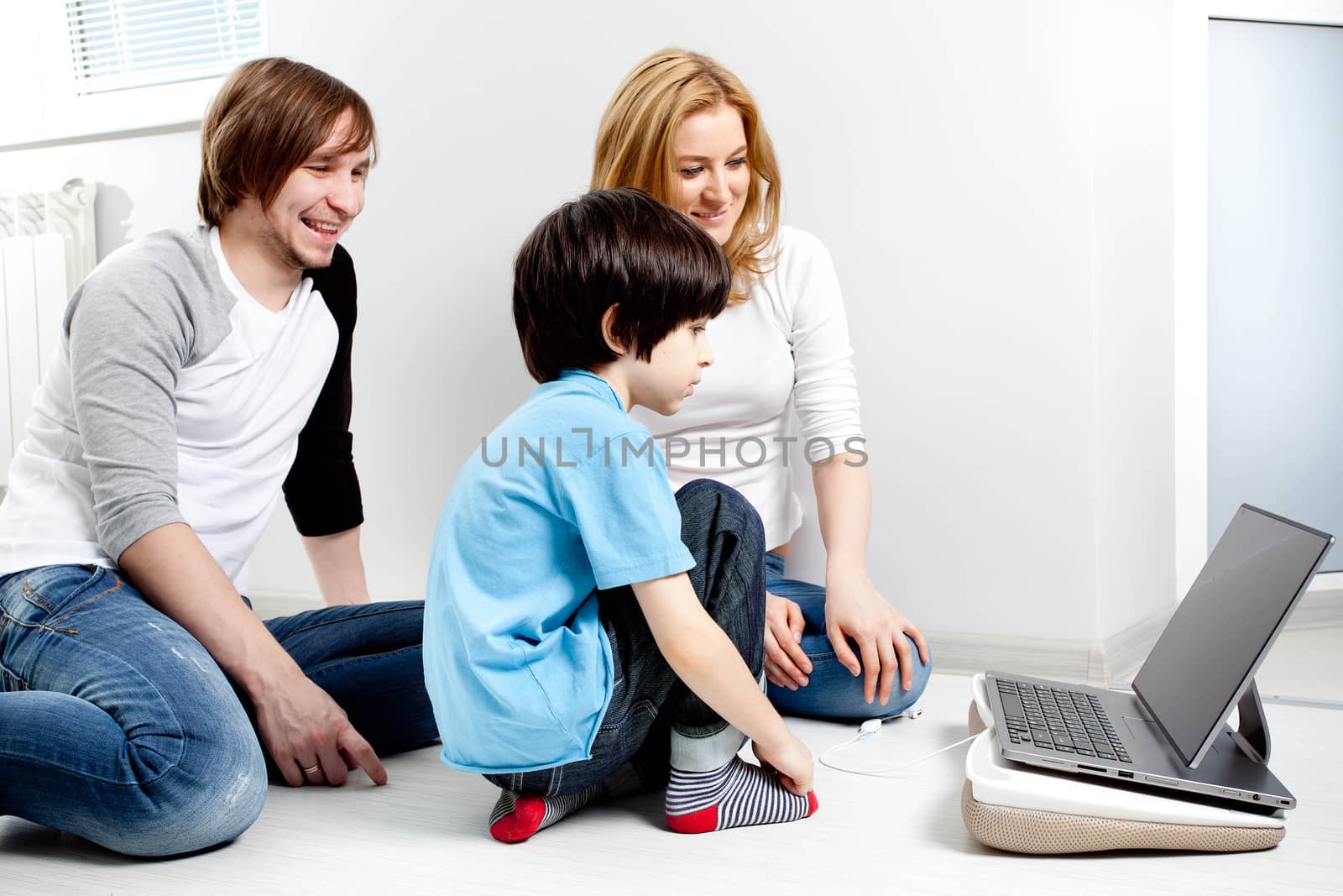 Young parents with child near laptop computer