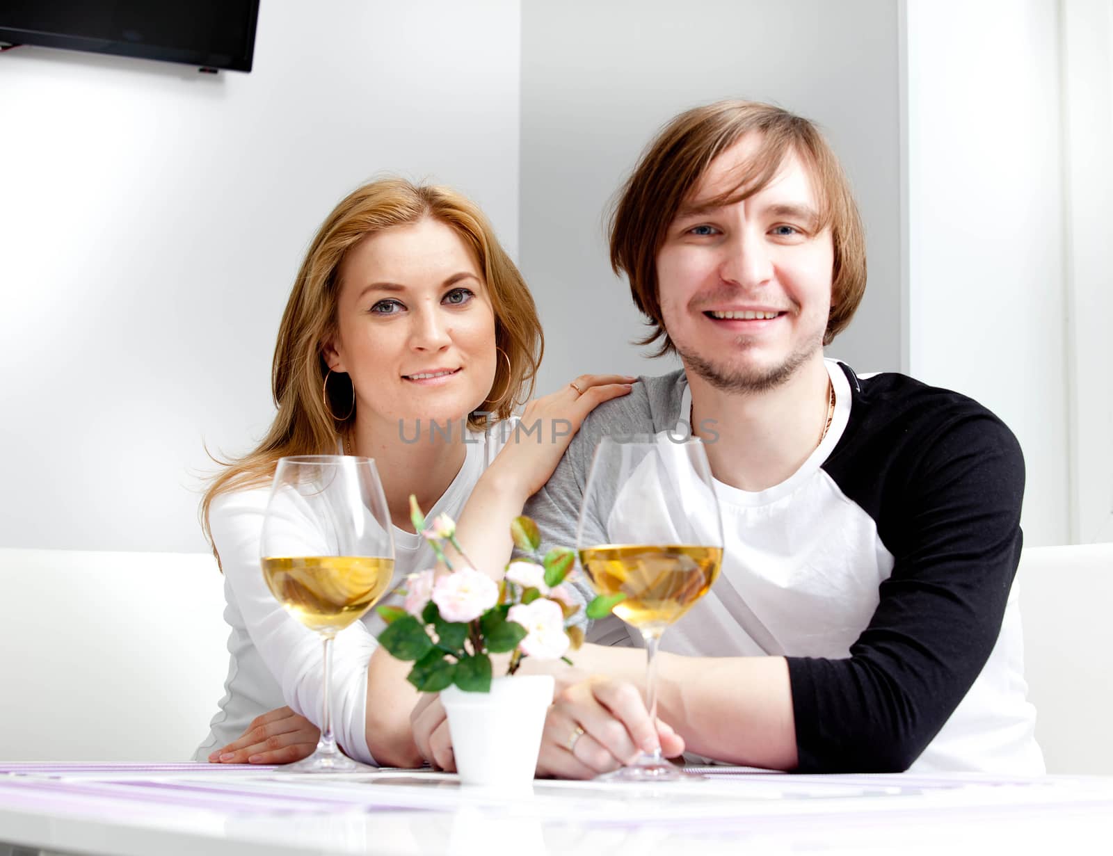 young woman in home having meal and wine with her husband