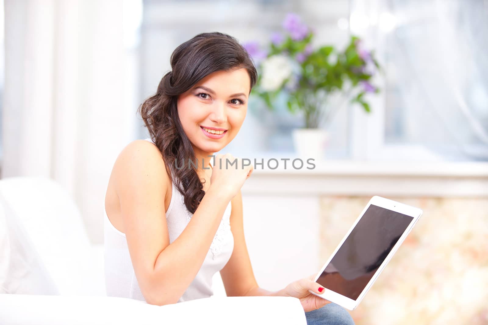 smiling young girl reading  tablet by Astroid