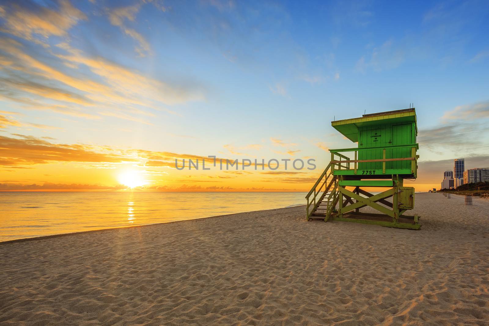 Miami South Beach sunrise with lifeguard tower and coastline with colorful cloud and blue sky. 