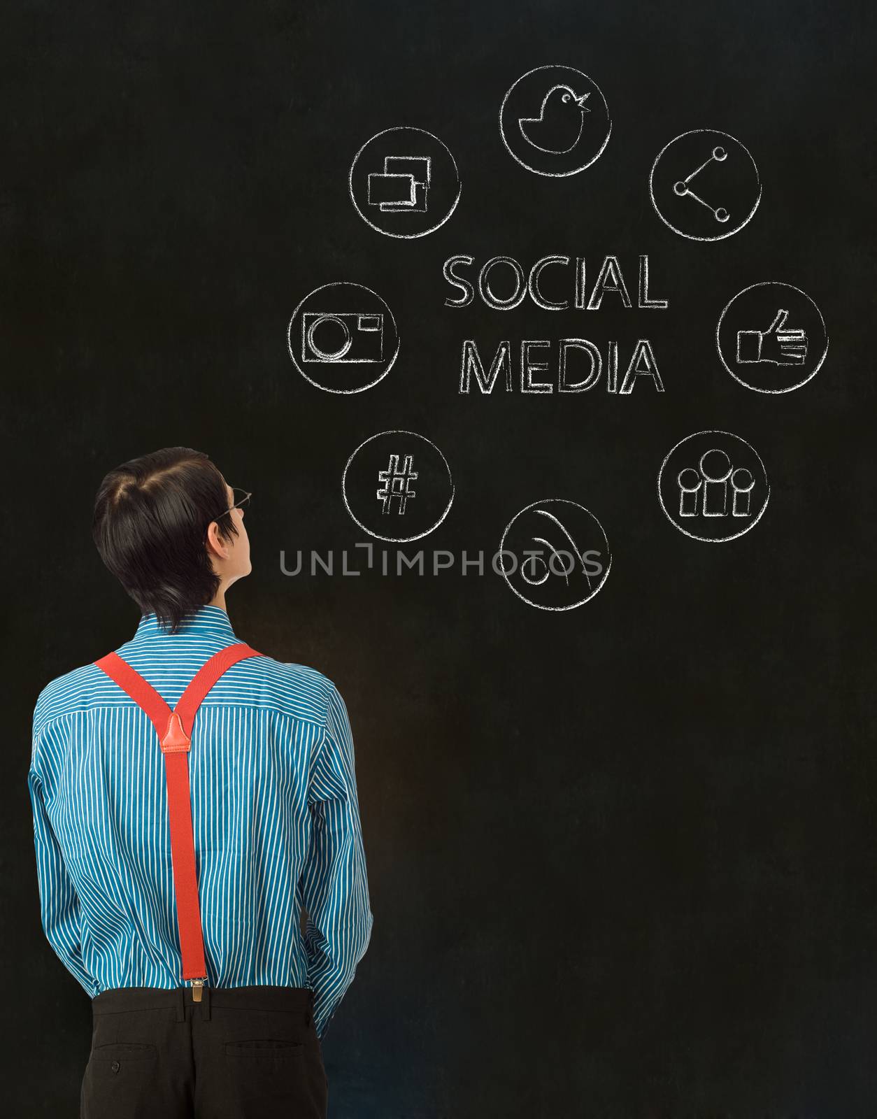 Nerd geek businessman with computer social media network icons on blackboard background