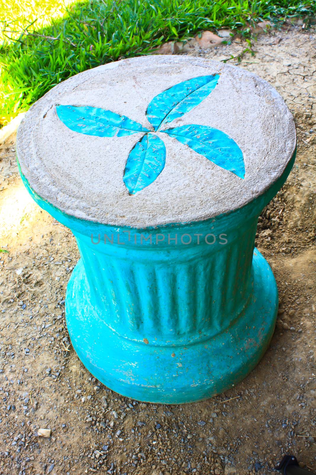 Leaf print on cement chair in garden