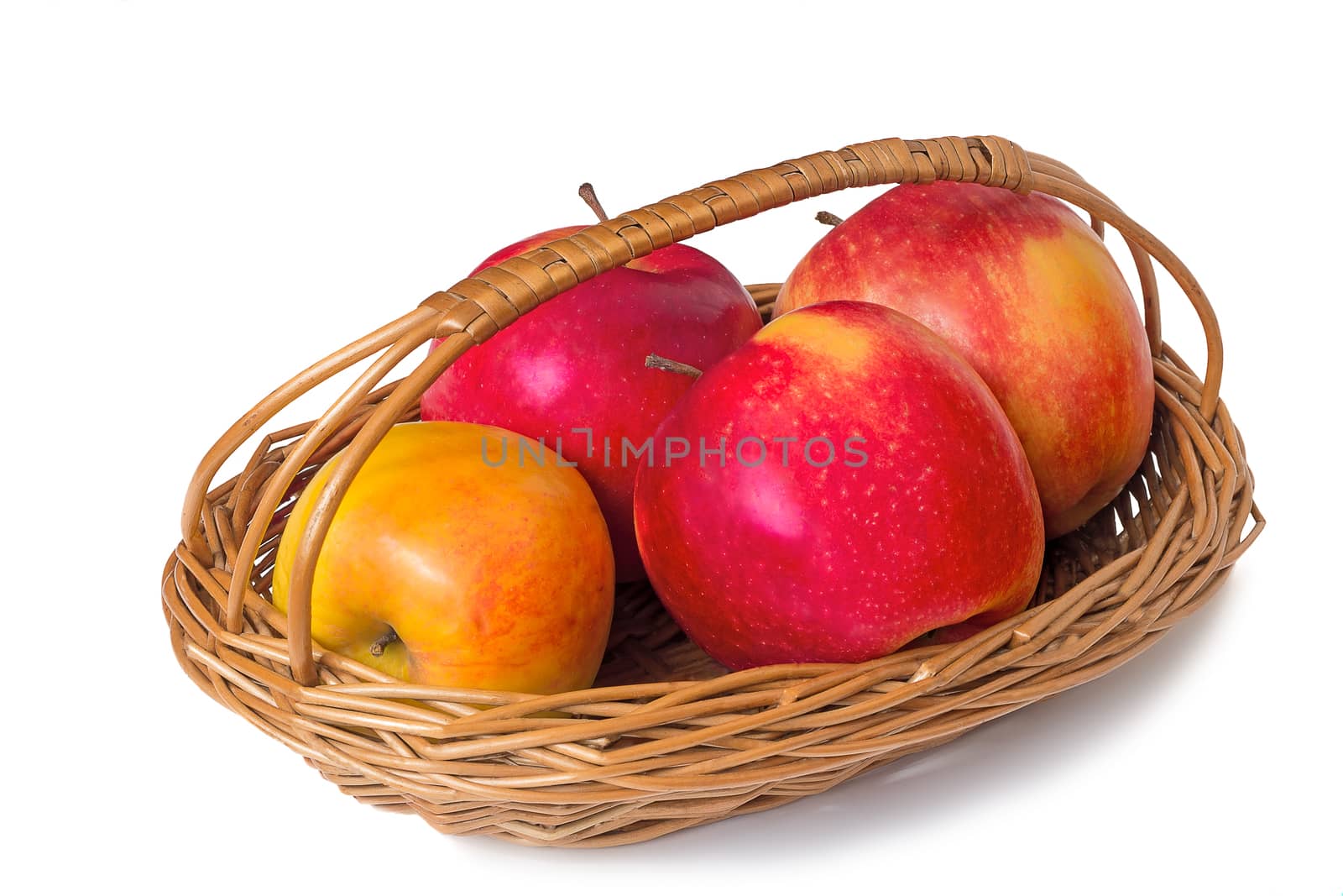 Big mature apples are in wattled to a basket on a table. Are presented on a white background.