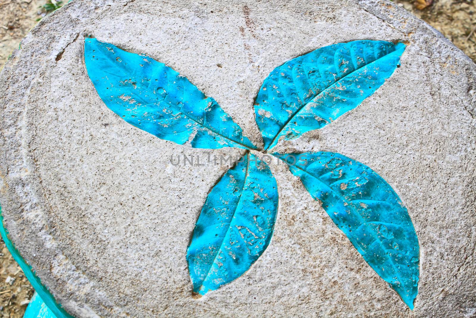 Leaf print on cement chair in garden