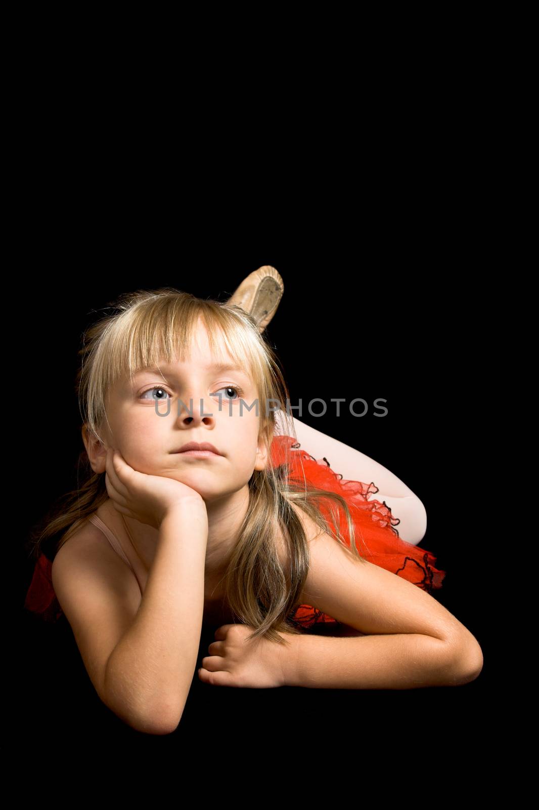 Young ballet dancer wearing a red costume