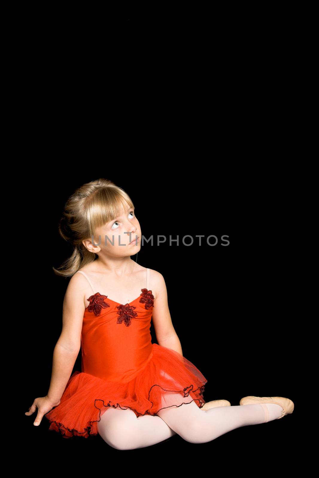 Young ballet dancer wearing a red costume