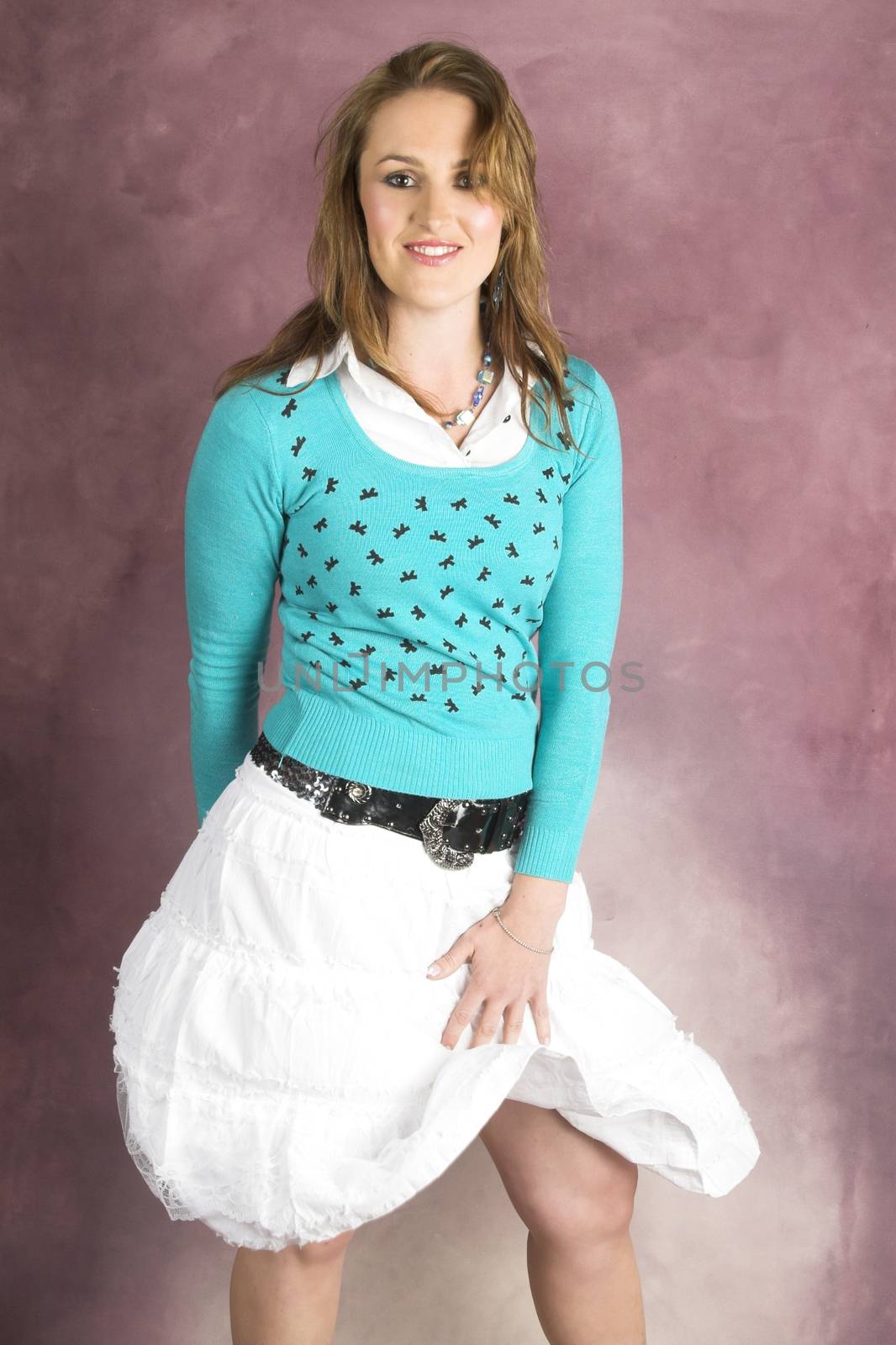 Beautiful young female wearing a white skirt and blue top