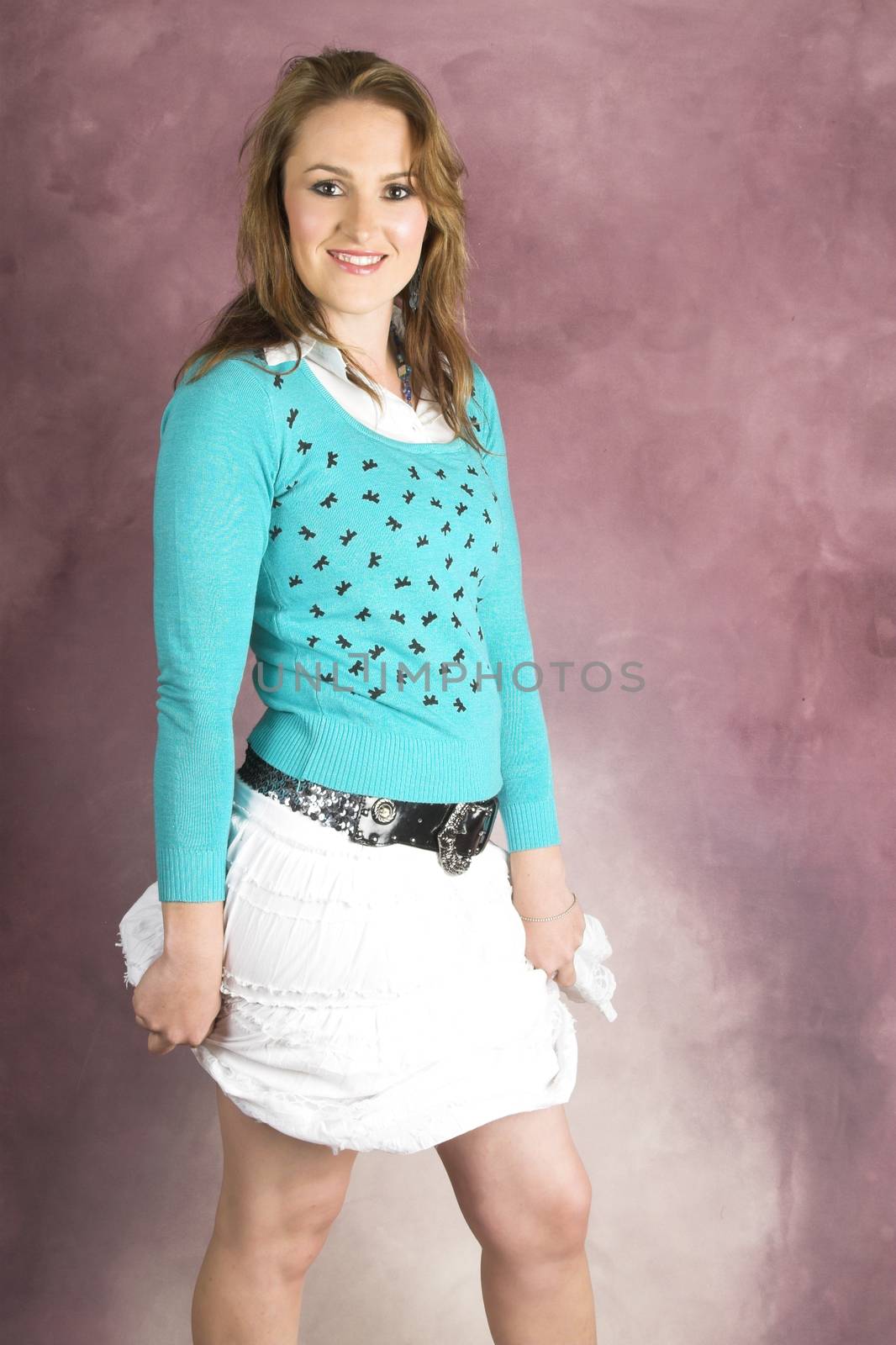 Beautiful young female wearing a white skirt and blue top