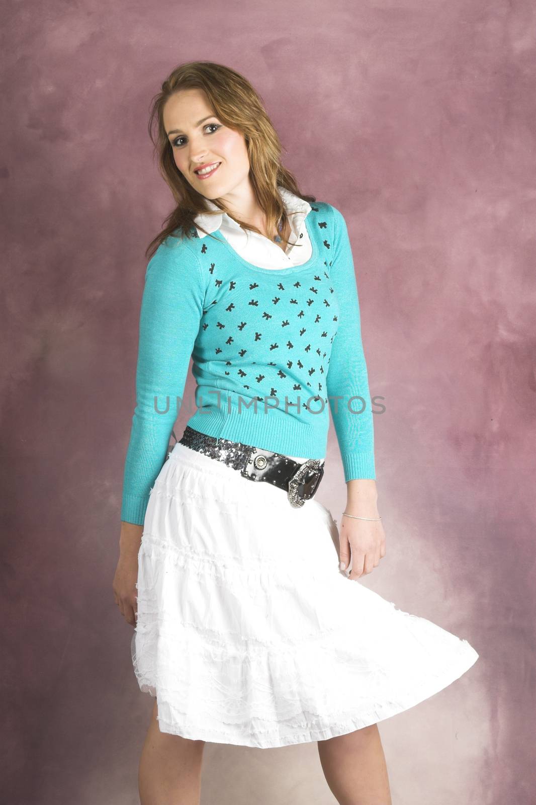 Beautiful young female wearing a white skirt and blue top