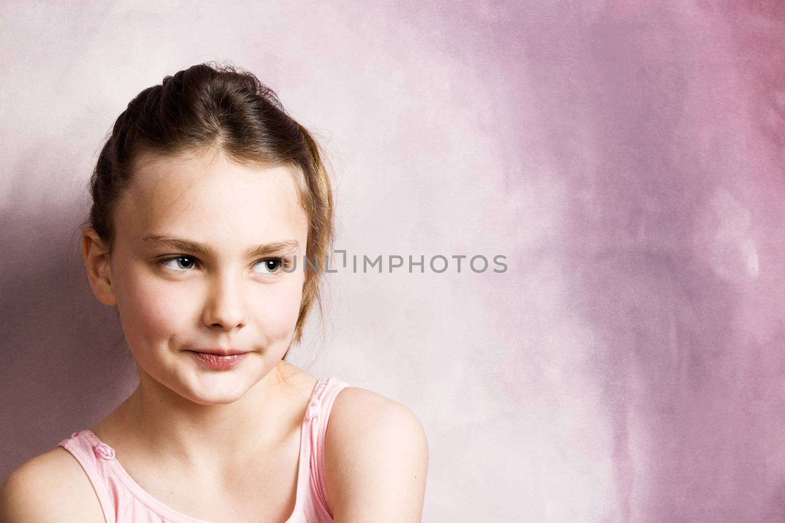 Young dancer wearing a pink costume with a beautiful expression