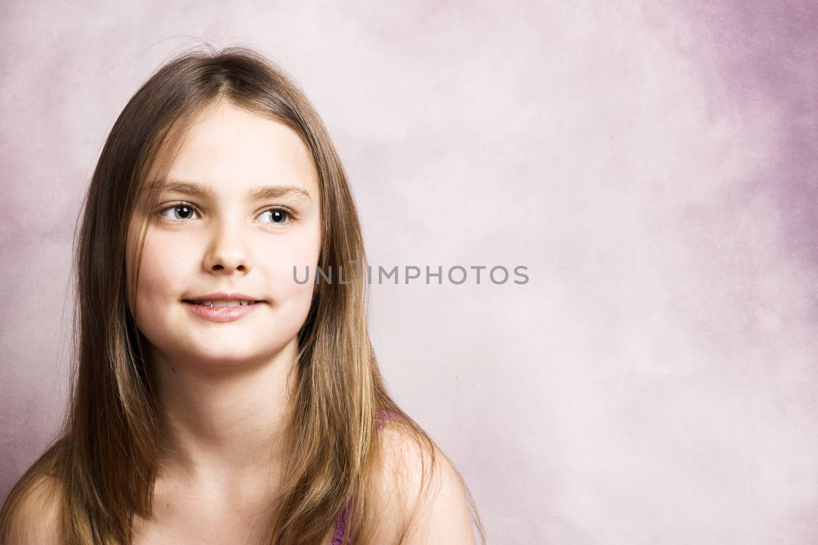 Beautiful young brunette against a pink background
Close up of a teen model with beautiful blue eyes
