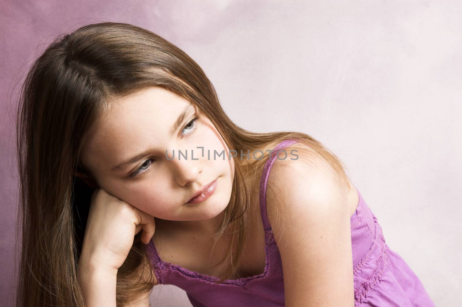 Beautiful young brunette against a pink background
