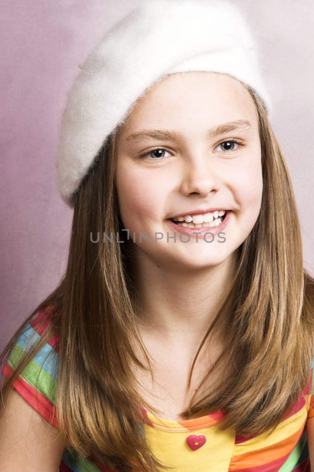 Beautiful young brunette against a pink background
