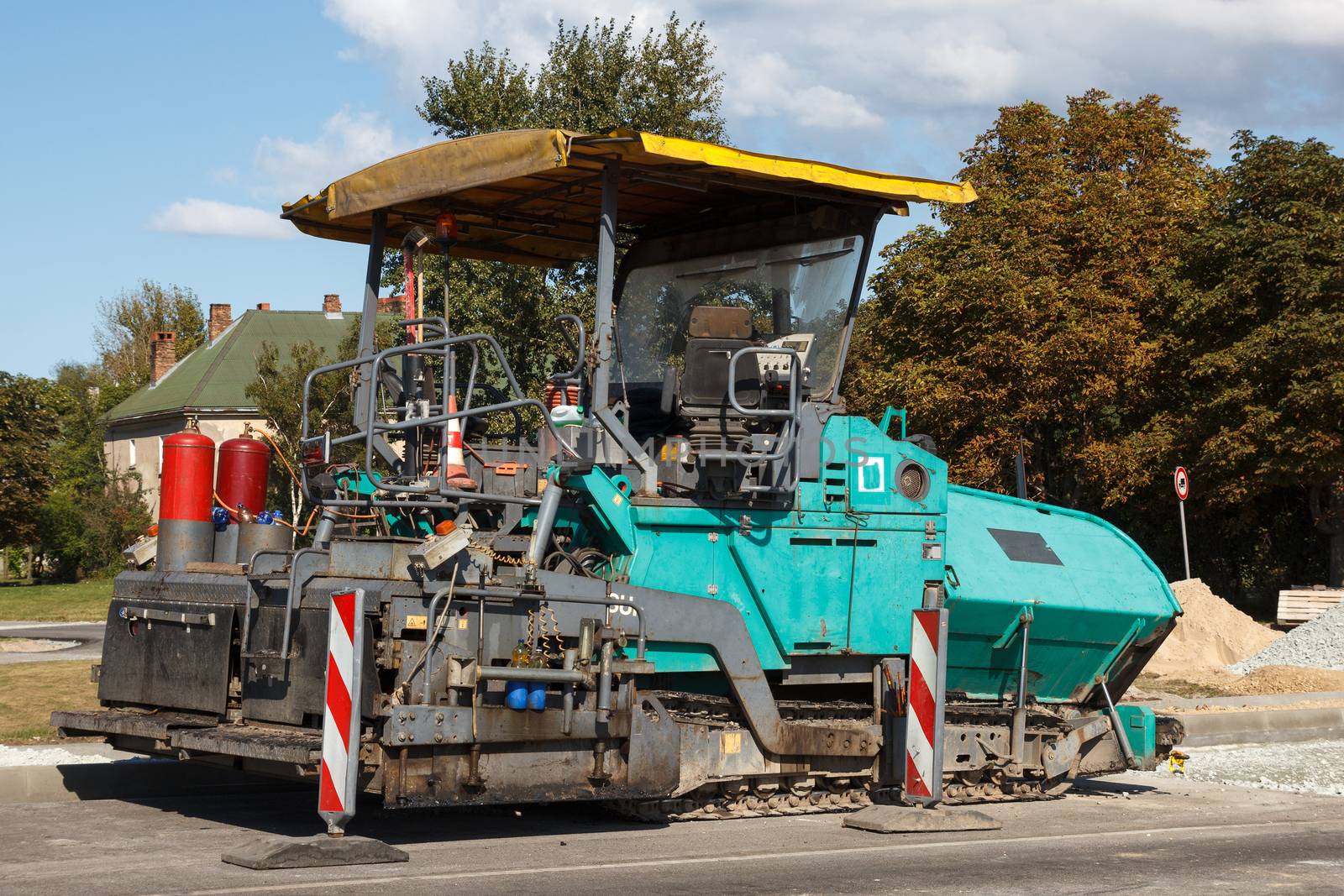 An asphalt paving machine at construction site on a street