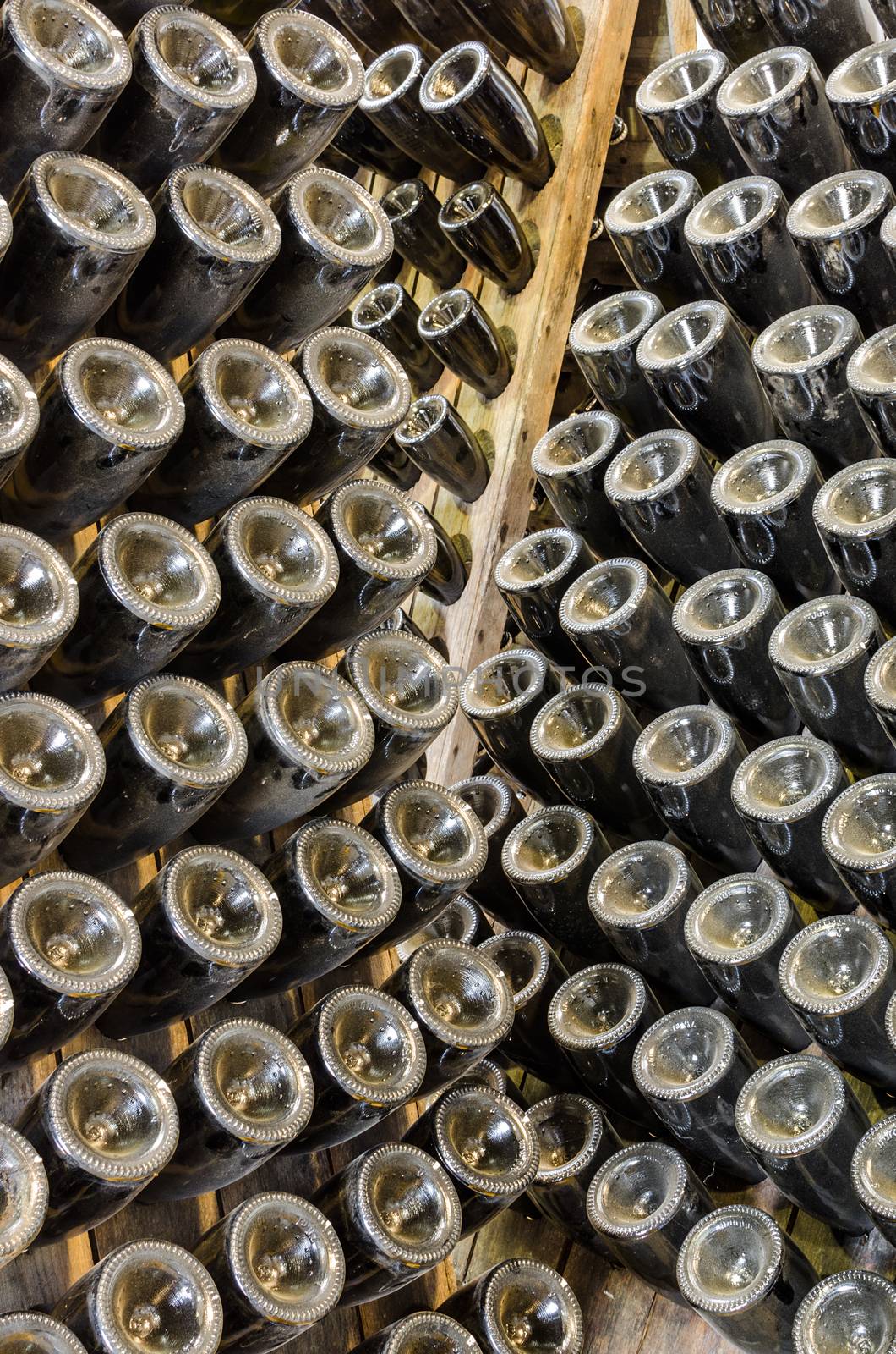 Traditional sparkling wines stored in the rack in cellar of winery