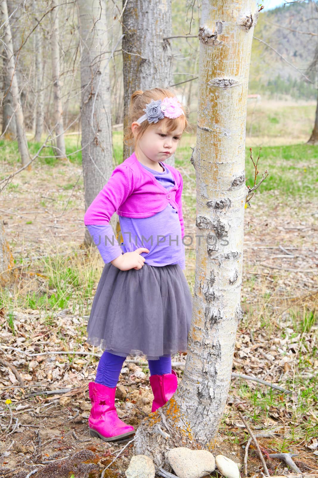 Little girl playing in the field during springtime
