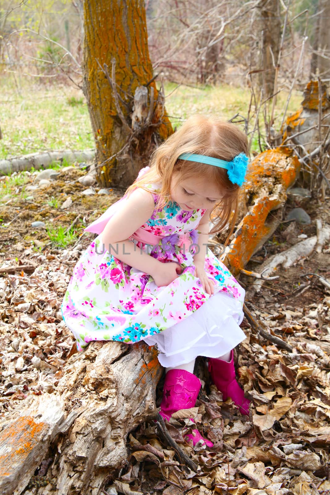 Little girl playing in the field during springtime