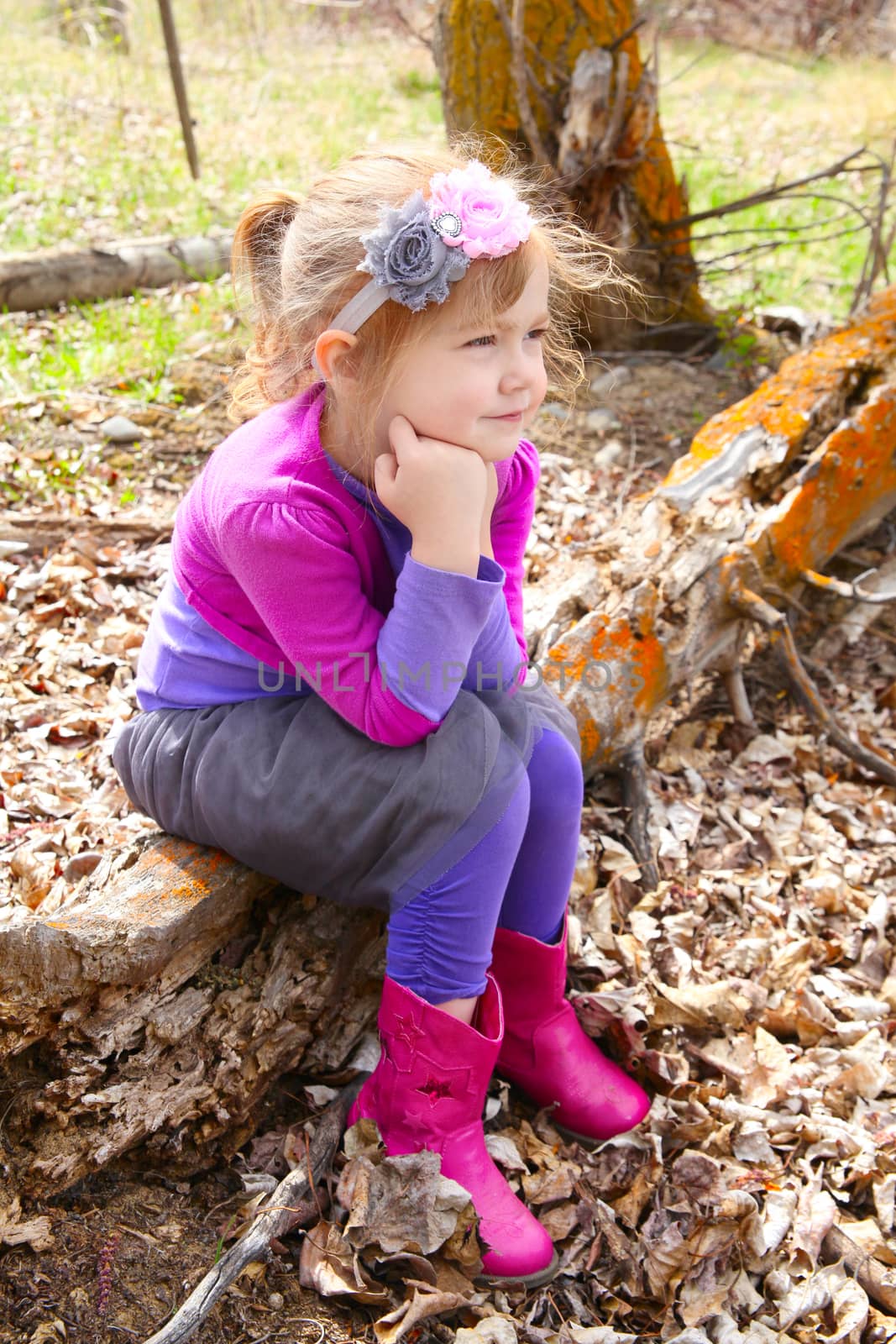 Little girl playing in the field during springtime