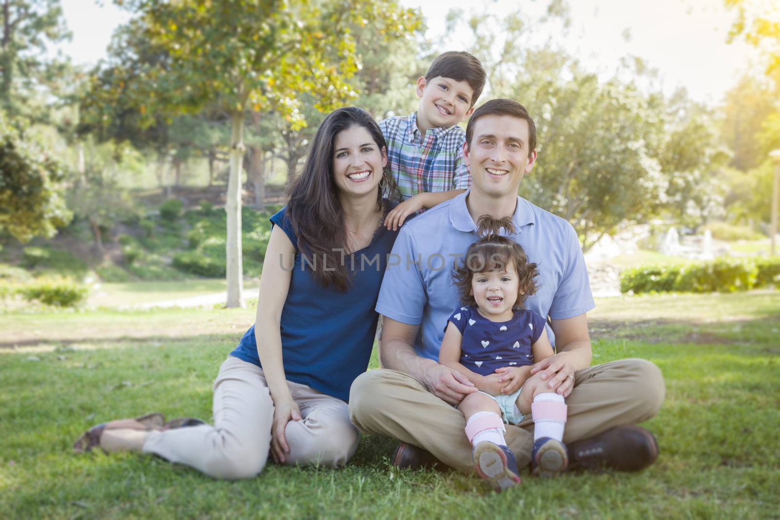 Attractive Young Mixed Race Family Outdoor Portrait in the Park.
