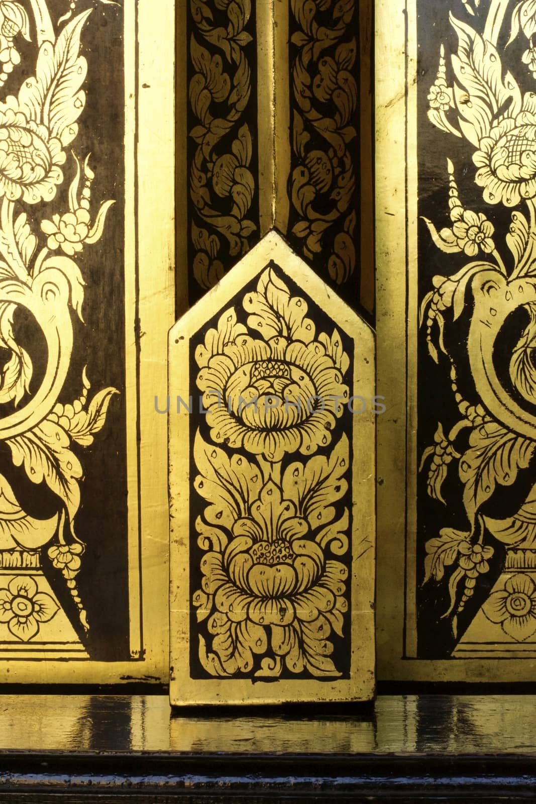 detail of thai pattern that made by covered wood plate with gold leaf for decorated temple door or pillar,shallow focus
