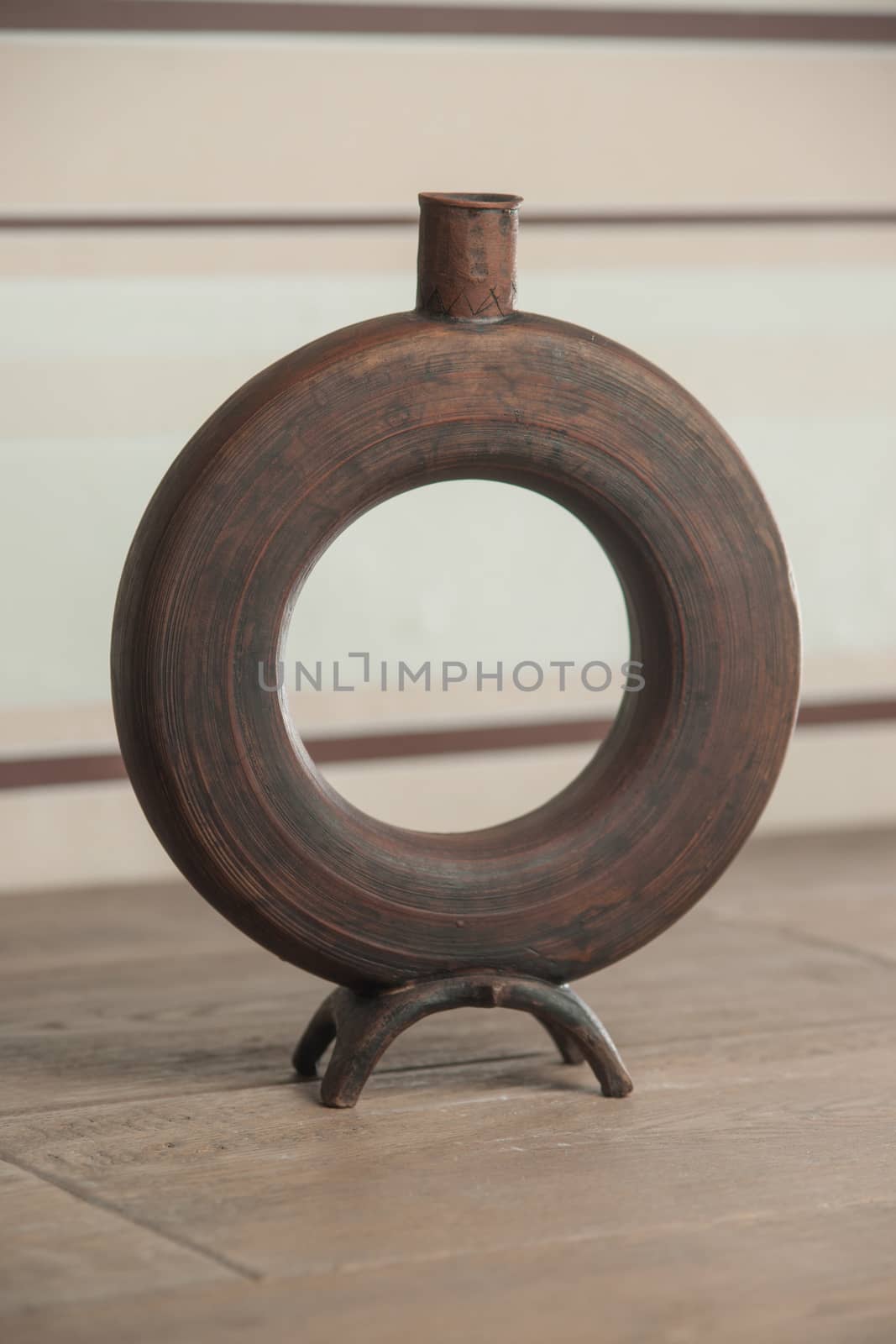 Traditional handcrafted vase of brown color on the table