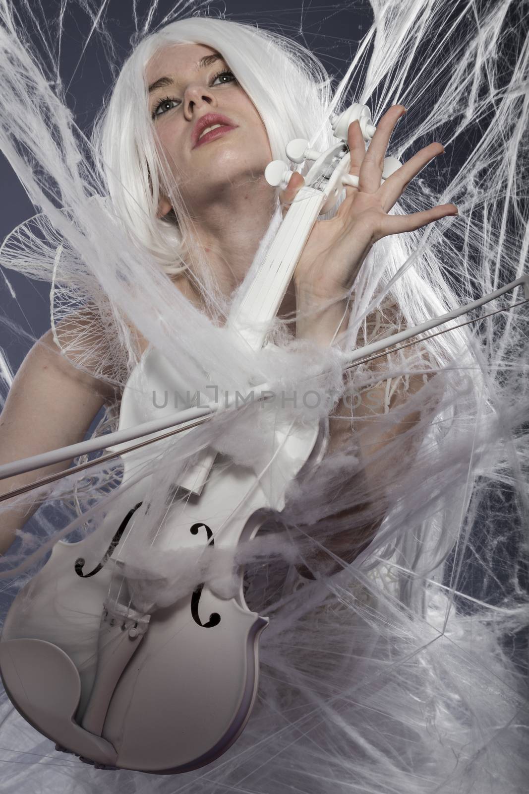 Lady, beautiful woman with couture gown in white, violin, music concept