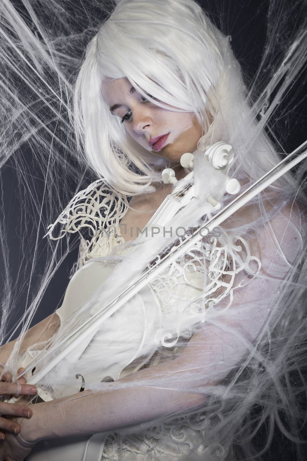 beautiful woman with couture gown in white, violin, music concept