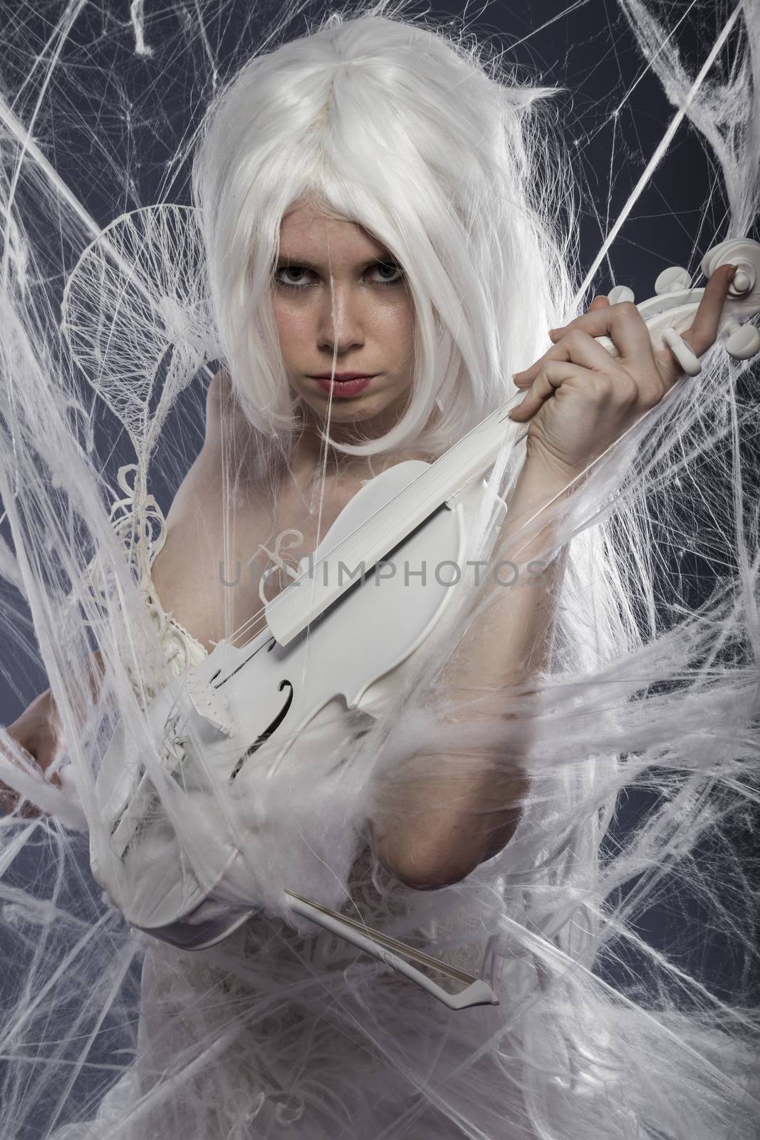 Pretty beautiful woman with couture gown in white, violin, music concept