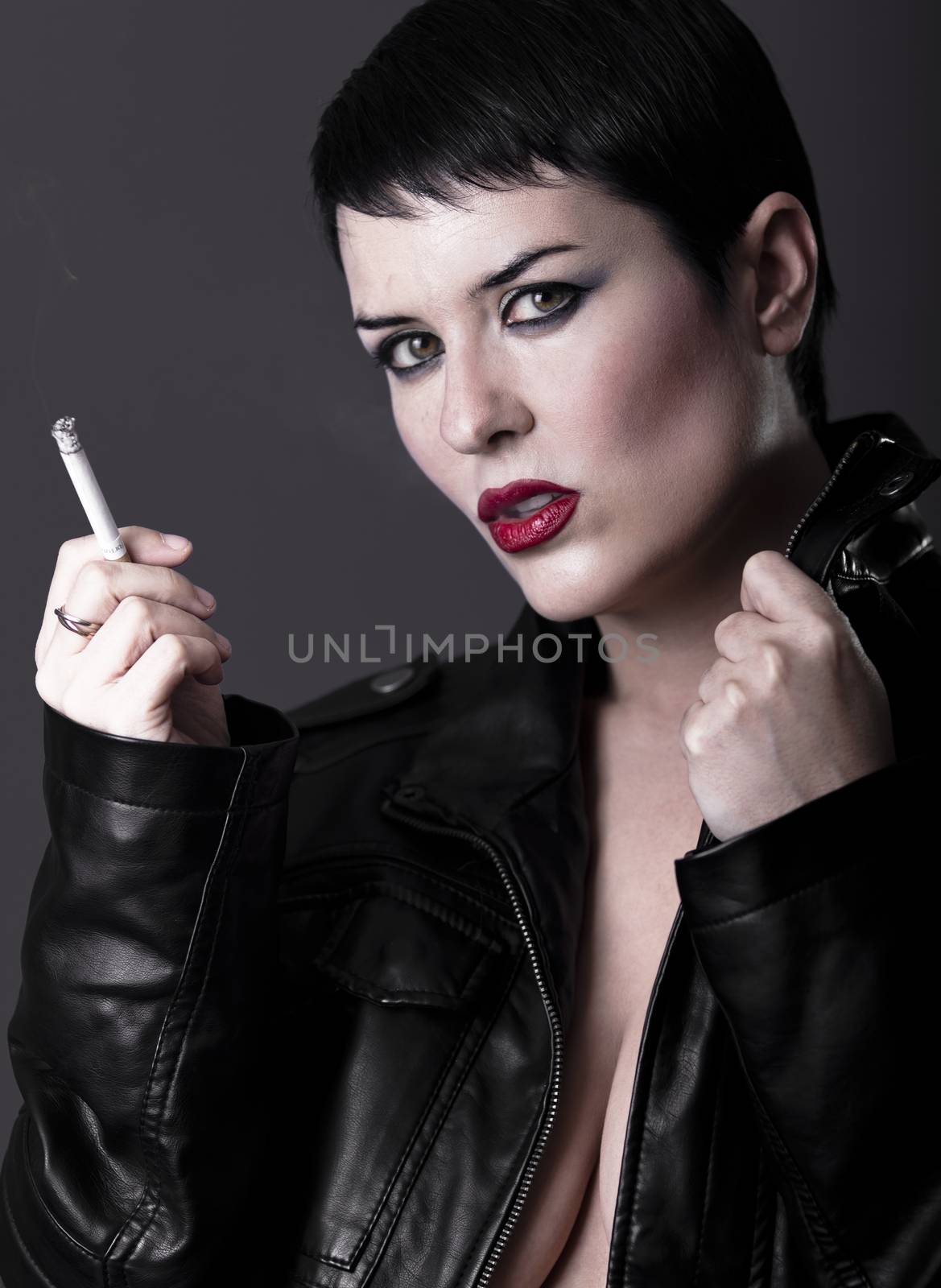 Naked woman with black leather jacket smoking a cigarette by FernandoCortes