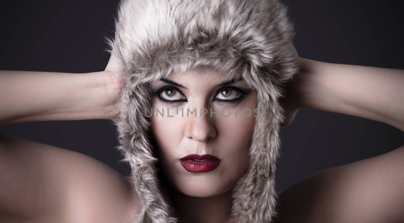 Nude woman with typical Russian fur hat looking up