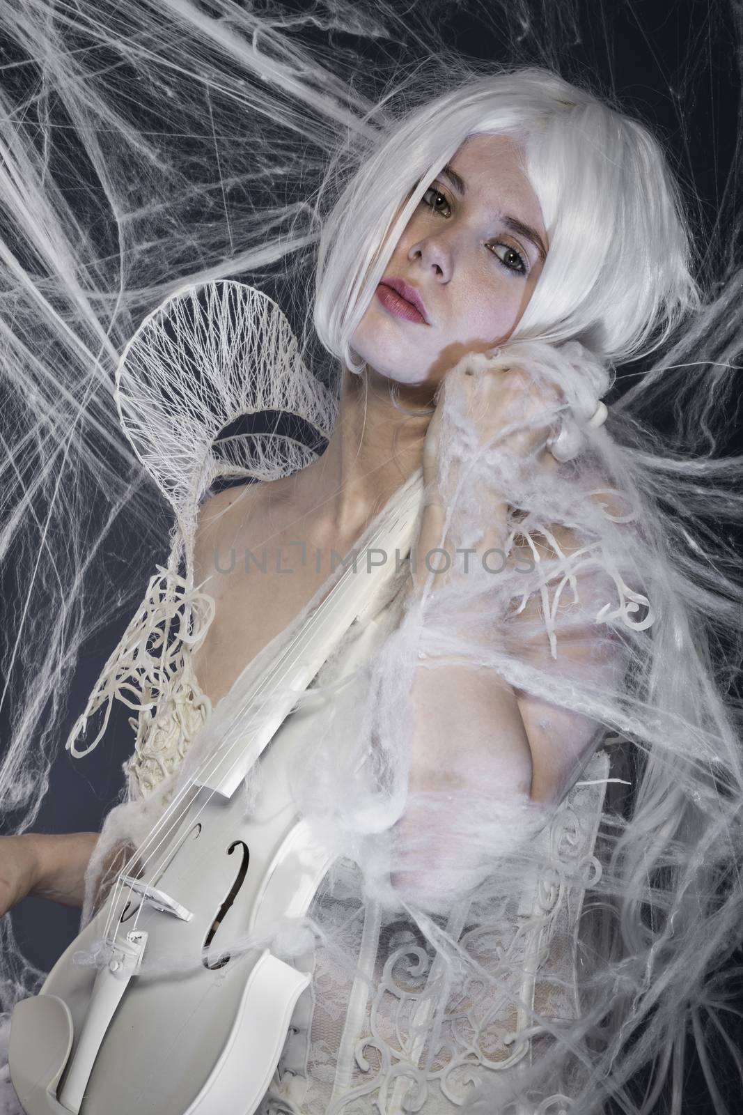 beautiful woman with couture gown in white, violin, music concep by FernandoCortes