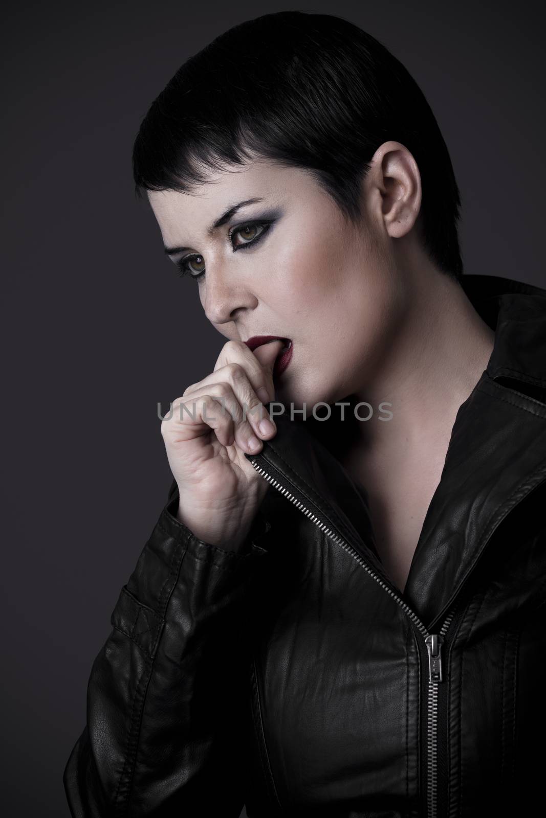 Proud sexy woman with black leather jacket biting her finger by FernandoCortes