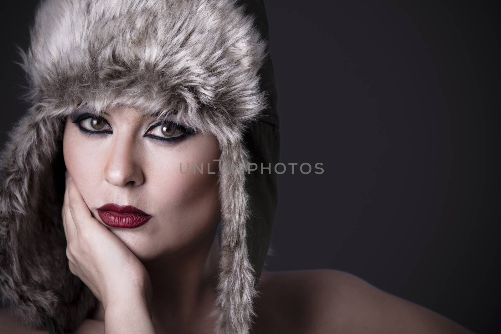 Woman frustrated with fur hat, winter concept by FernandoCortes