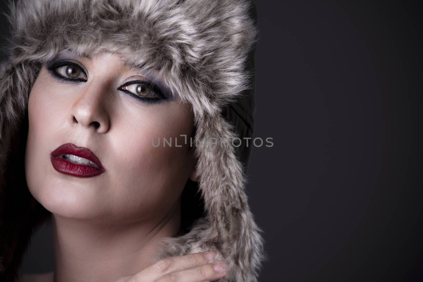 Elegant nude woman with typical Russian fur hat and perfect skin