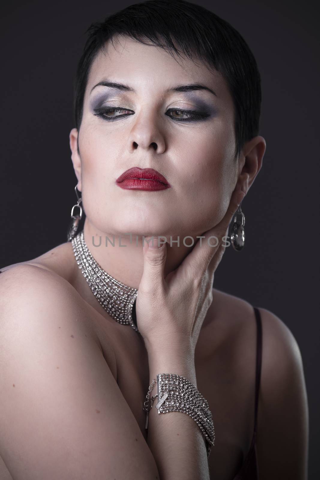 Sexy woman with elegant silver jewelry stroking his cheek by FernandoCortes