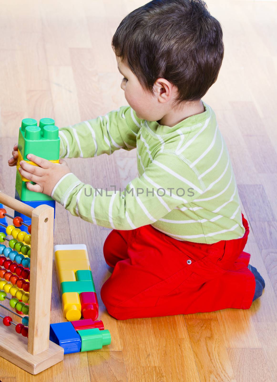 Education, cute little boy playing with blocks by FernandoCortes