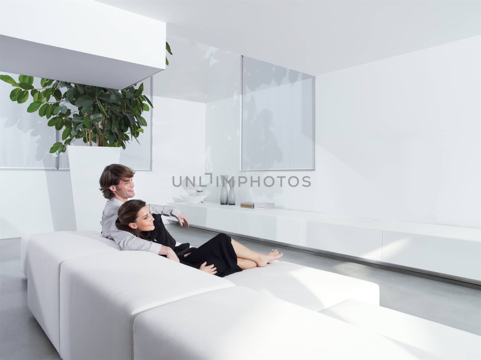 Relaxed young couple at home by toocan