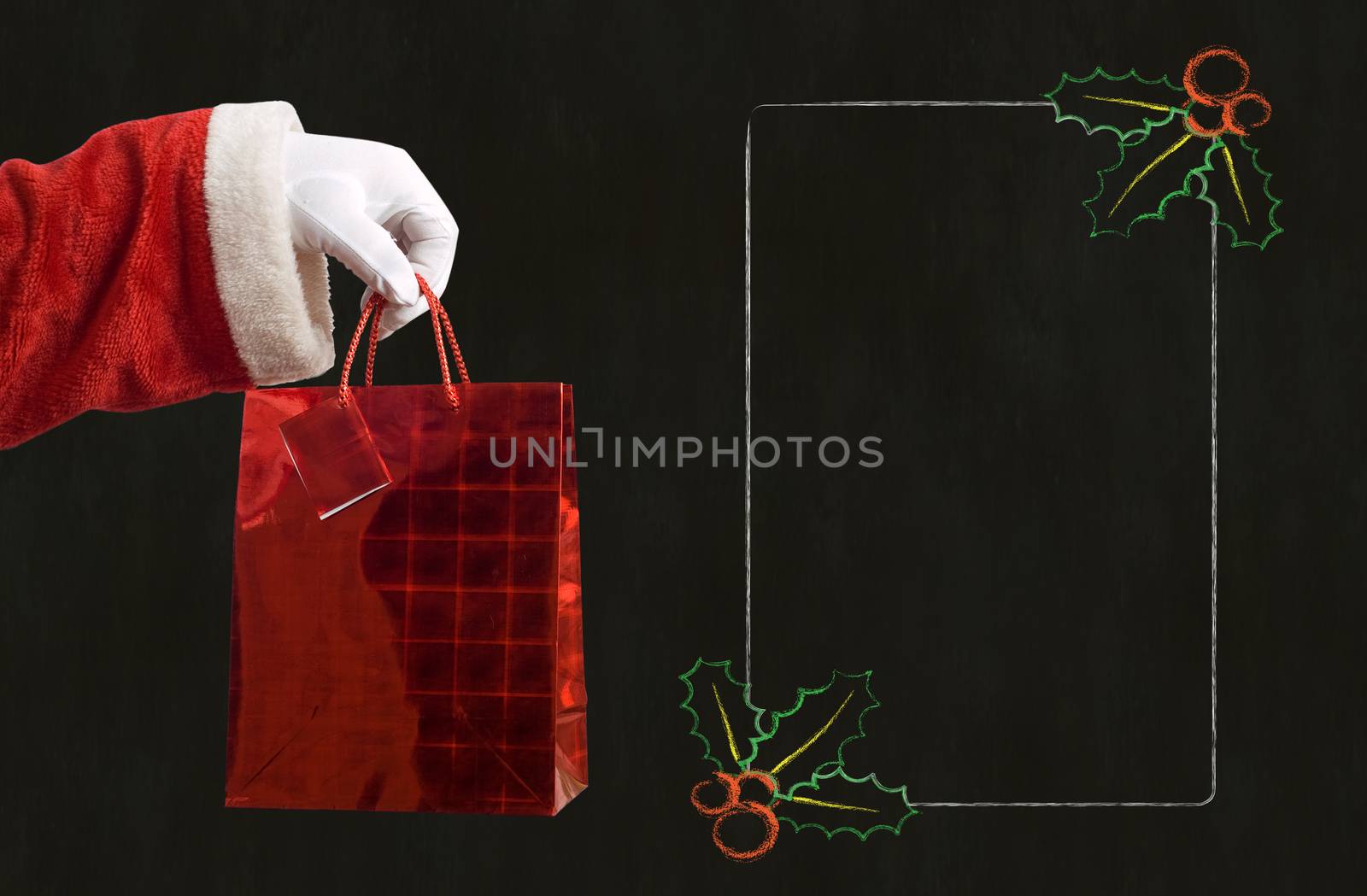 Father Christmas hand holding a red present with notes