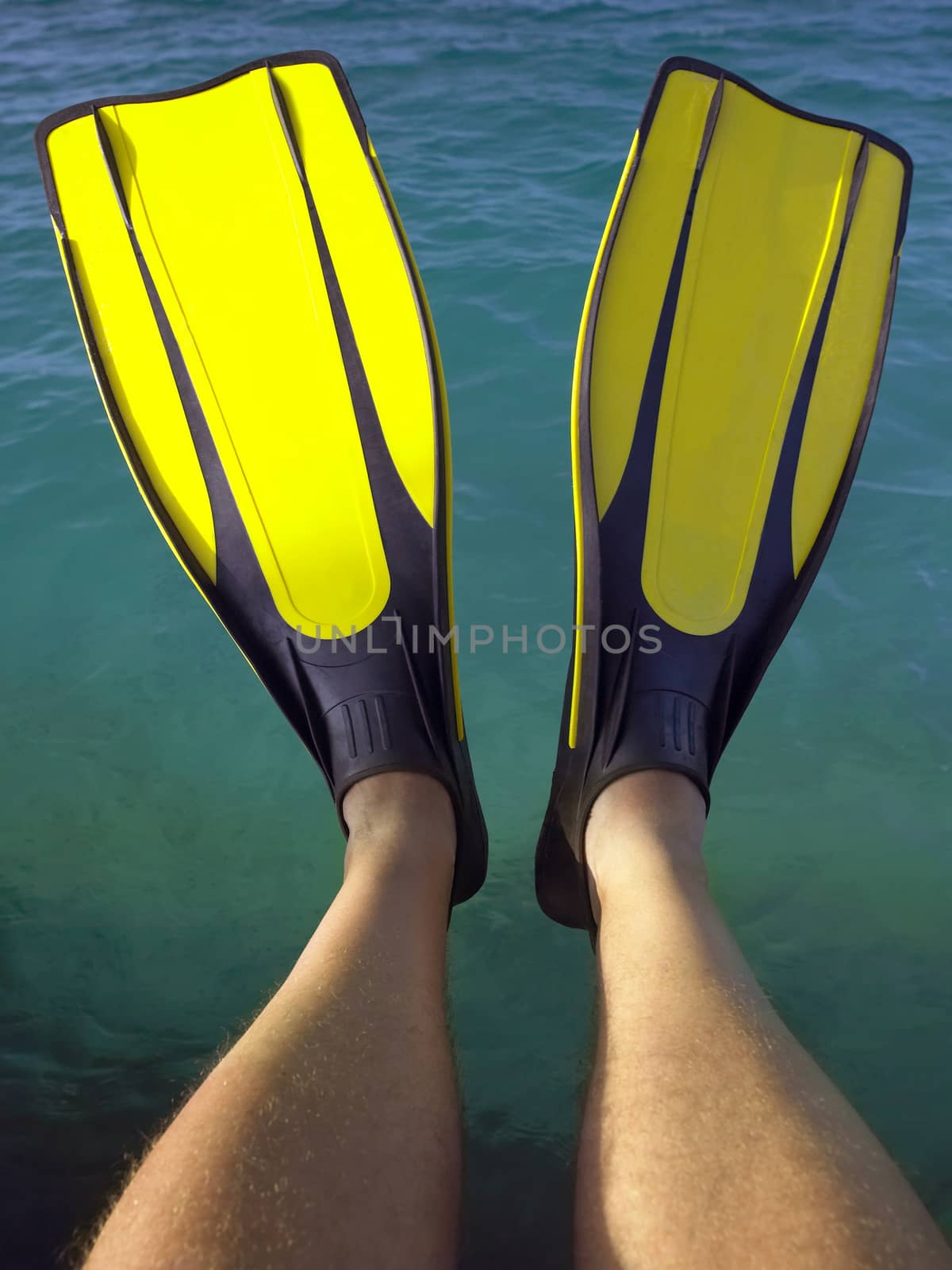 Man wearing flippers on a tropical vacation in the Maldives in the Indian Ocean