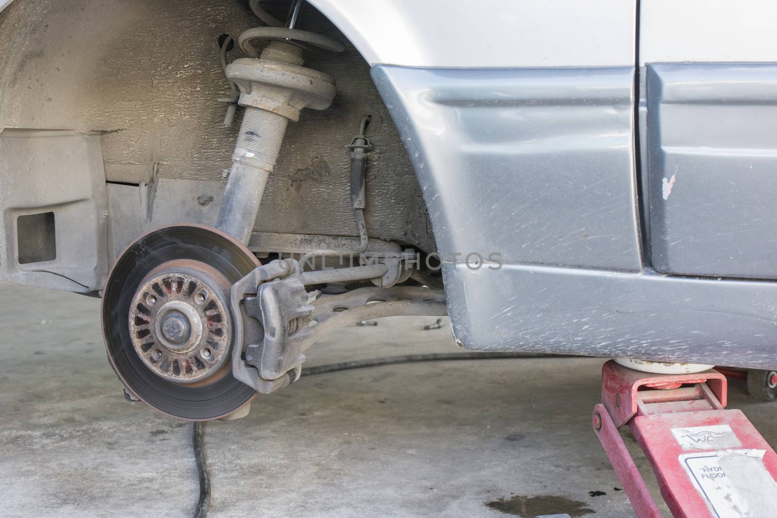 Closeup car disc brakes servicing for replacement tire
