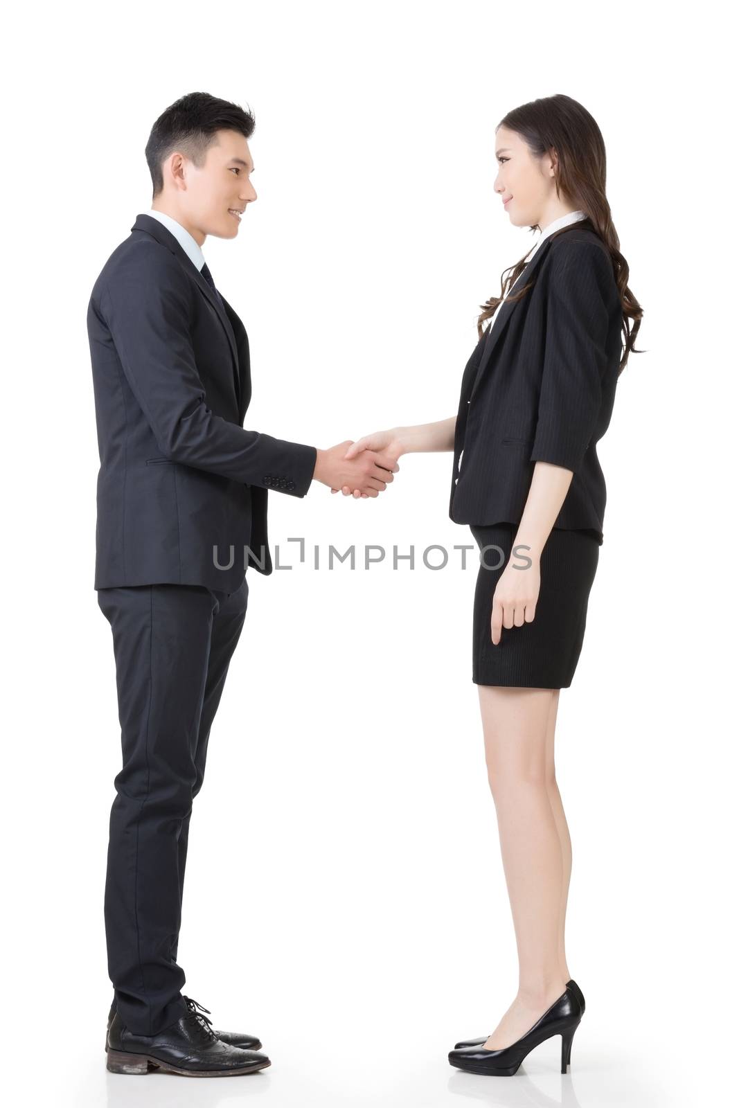 Asian business man and woman shake hands, full length portrait isolated on white background.