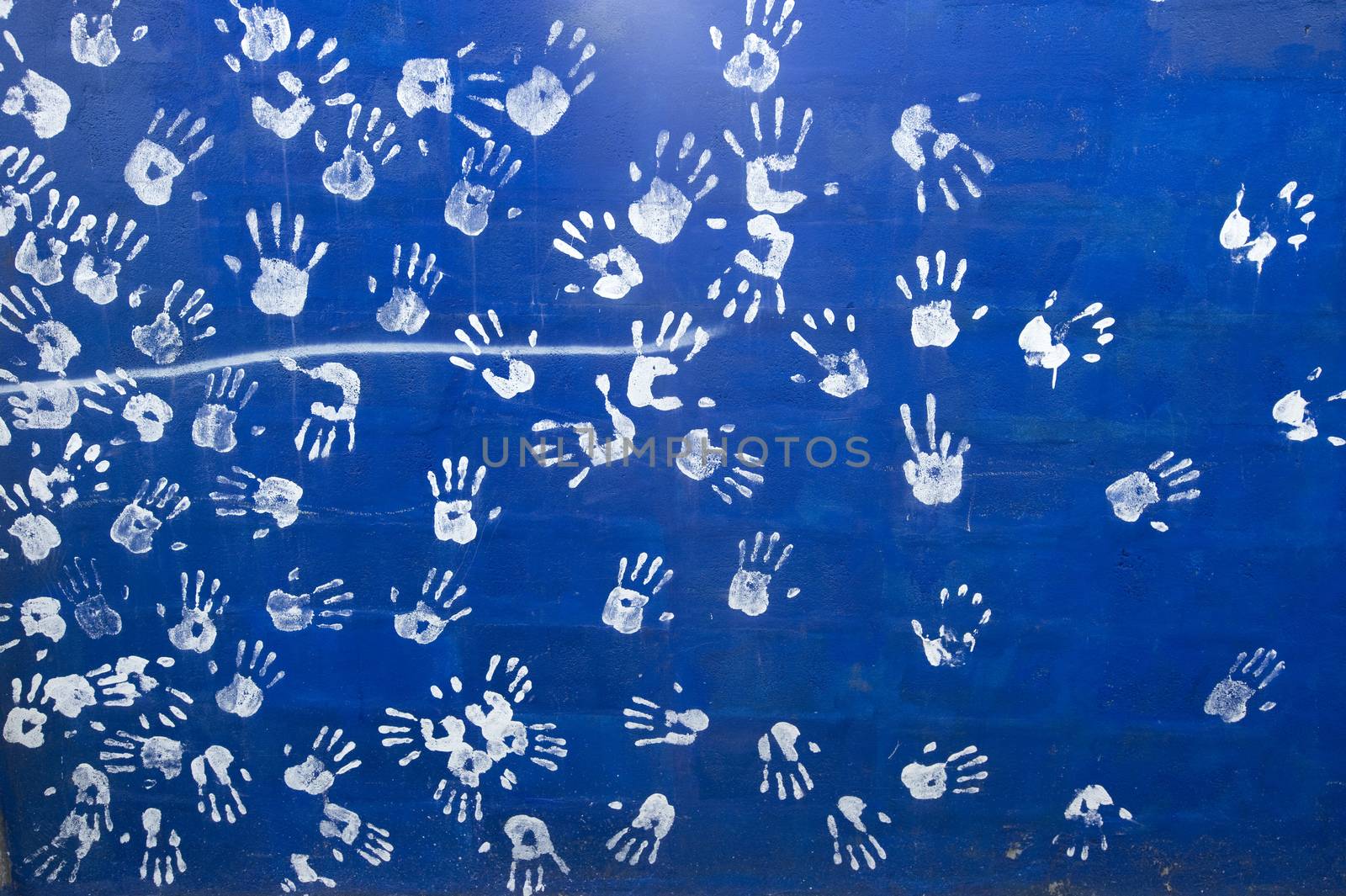 white handprints on a blue wall