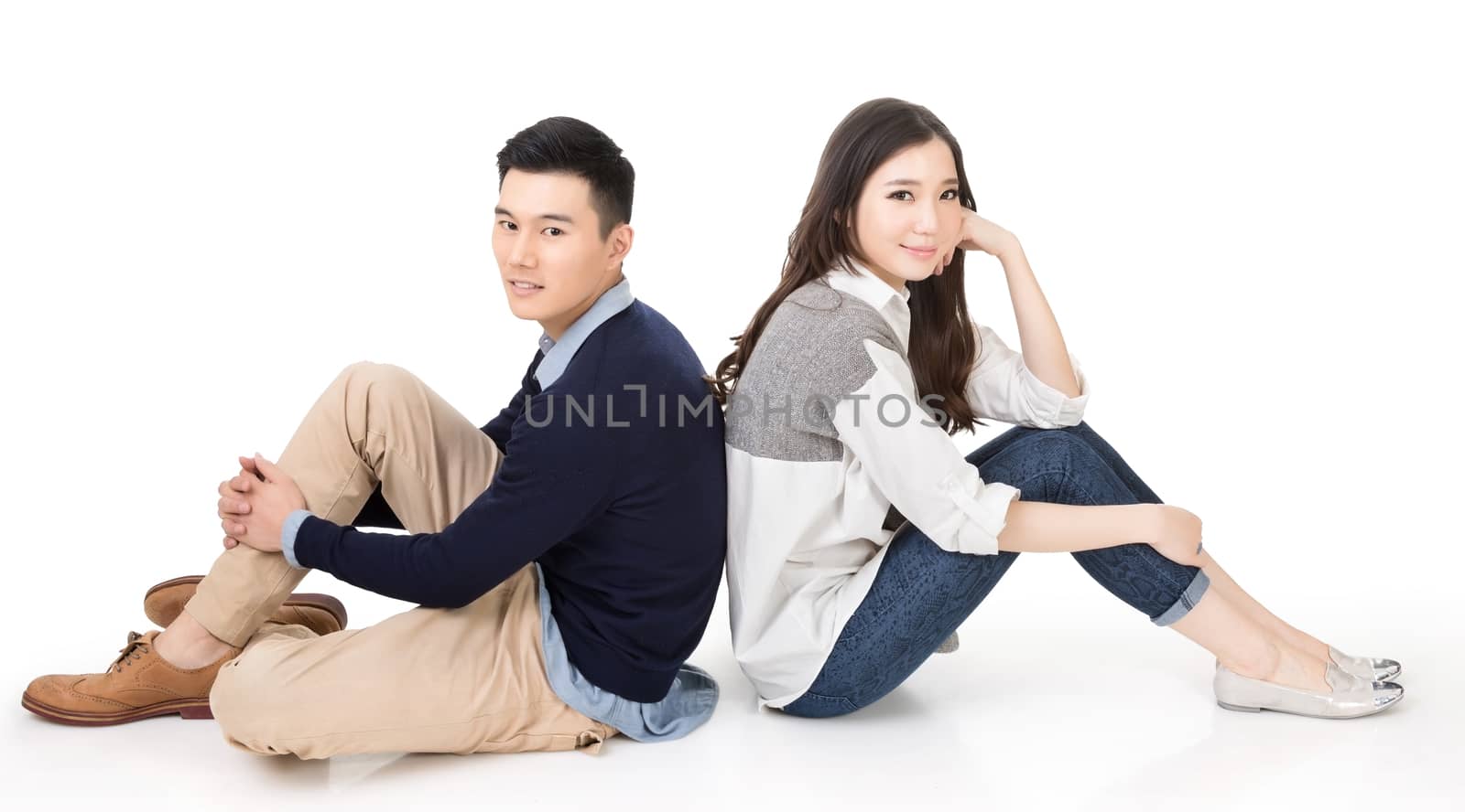 Young Asian couple sit on ground by elwynn