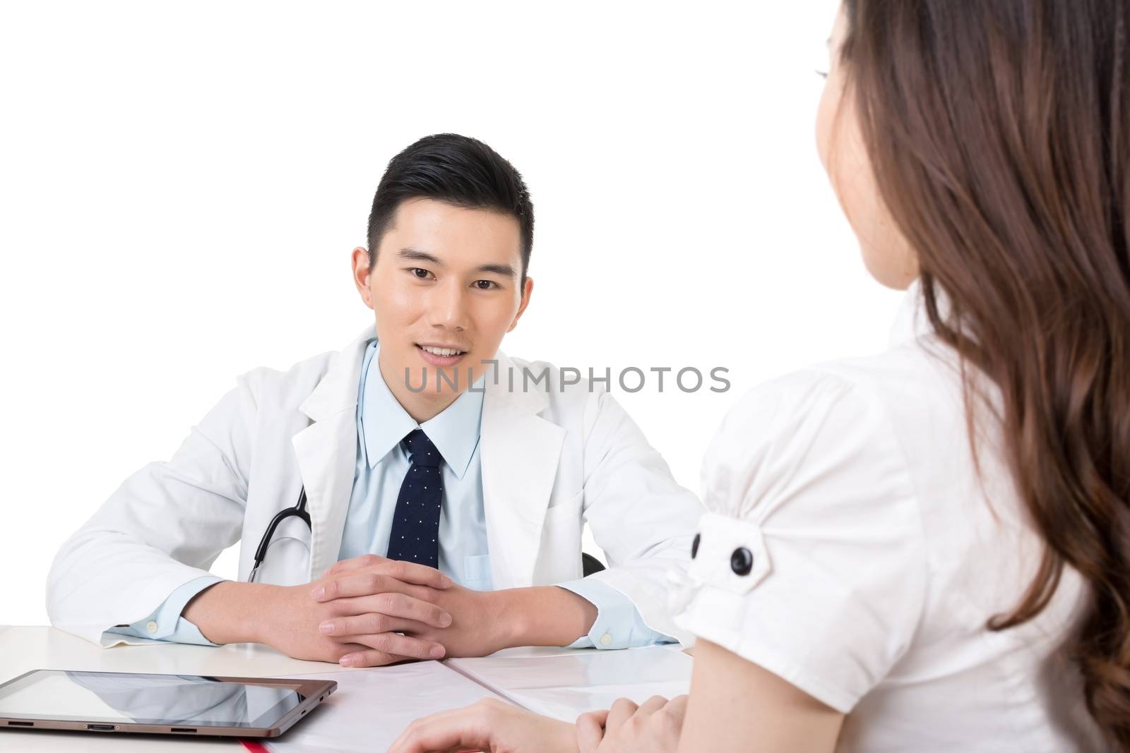 Young Asian medicine doctor sit and look at you.